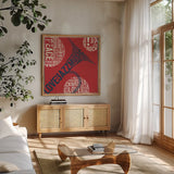 Type Trumpet Square Red and Blue by Michael Mullan. Shown in a natural wood frame in a cozy modern living room. Available as an archival giclee rolled canvas, fine art paper, or poster print. SKU 51060a.