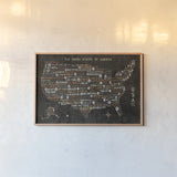 US City Map Black by Michael Mullan. shown as a paper print in a natural frame. Available as a archival giclee rolled canvas, fine art paper, or poster print. SKU 20462i.