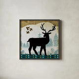 Woodland Dwellers Black Deer II by Michael Mullan. Shown in a sleek black glass frame for a contemporary gallery look. Available as an archival giclee rolled canvas, fine art paper, or poster print. SKU 50492a.