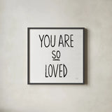 You Are So Loved Sq BW by Michael Mullan. Shown in a sleek black glass frame for a contemporary gallery look. Available as an archival giclee rolled canvas, fine art paper, or poster print. SKU 54659a.
