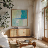 Blue Water II by Mike Schick. Shown in a natural wood frame in a cozy modern living room. Available as an archival giclee rolled canvas, fine art paper, or poster print. SKU 17470a.