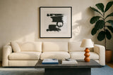 Gold and Black Elements XVII by Mike Schick. Displayed in a glass frame with matte in a clean modern living room. Available as an archival giclee rolled canvas, fine art paper, or poster print. SKU 19473a.