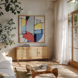 Primaries by Mike Schick. Shown in a natural wood frame in a cozy modern living room. Available as an archival giclee rolled canvas, fine art paper, or poster print. SKU 36359a.