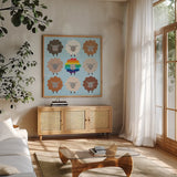 Be Ewe Brown and Rainbow Sheep Sq by Moira Hershey. Shown in a natural wood frame in a cozy modern living room. Available as an archival giclee rolled canvas, fine art paper, or poster print. SKU 66184a.