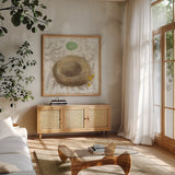Botanical Nest II by Moira Hershey. Shown in a natural wood frame in a cozy modern living room. Available as an archival giclee rolled canvas, fine art paper, or poster print. SKU 8384a.