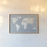 Calm World Map by Moira Hershey. shown as a paper print in a natural frame. Available as a archival giclee rolled canvas, fine art paper, or poster print. SKU 43403i.