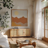 Desert Sun II by Moira Hershey. Shown in a natural wood frame in a cozy modern living room. Available as an archival giclee rolled canvas, fine art paper, or poster print. SKU 57268a.