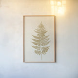 Fern Print I Gold No Shiplap by Moira Hershey. shown as a paper print in a natural frame. Available as a archival giclee rolled canvas, fine art paper, or poster print. SKU 57690h.