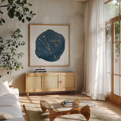 Horoscope Taurus by Moira Hershey. Shown in a natural wood frame in a cozy modern living room. Available as an archival giclee rolled canvas, fine art paper, or poster print. SKU 48908a.