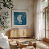 Night Sky Rest Well by Moira Hershey. Shown in a natural wood frame in a cozy modern living room. Available as an archival giclee rolled canvas, fine art paper, or poster print. SKU 49902a.