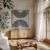 Over the Rainbow I Navy Gray by Moira Hershey. Shown in a natural wood frame in a cozy modern living room. Available as an archival giclee rolled canvas, fine art paper, or poster print. SKU 56162a.