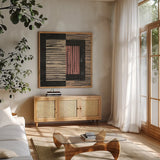 Primitive II Terra Cotta by Moira Hershey. Shown in a natural wood frame in a cozy modern living room. Available as an archival giclee rolled canvas, fine art paper, or poster print. SKU 59457a.