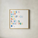 Rainbow Words I by Moira Hershey. Shown in a natural wood glass frame for a timeless modern aesthetic. Available as an archival giclee rolled canvas, fine art paper, or poster print. SKU 64357a.