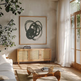 Scribbly Black II by Moira Hershey. Shown in a natural wood frame in a cozy modern living room. Available as an archival giclee rolled canvas, fine art paper, or poster print. SKU 54587a.