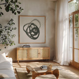 Scribbly Black III by Moira Hershey. Shown in a natural wood frame in a cozy modern living room. Available as an archival giclee rolled canvas, fine art paper, or poster print. SKU 54588a.