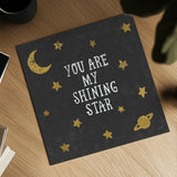 Shining Star Black 6x6 by Moira Hershey. Shown as a detailed flat fine art print, highlighting archival giclee quality. Available as an archival giclee rolled canvas, fine art paper, or poster print. SKU 17151a.