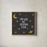 Shining Star Black 6x6 by Moira Hershey. Shown in a natural wood glass frame for a timeless modern aesthetic. Available as an archival giclee rolled canvas, fine art paper, or poster print. SKU 17151a.