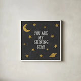 Shining Star Black 6x6 by Moira Hershey. Shown in a crisp white glass frame for a clean and minimalist style. Available as an archival giclee rolled canvas, fine art paper, or poster print. SKU 17151a.