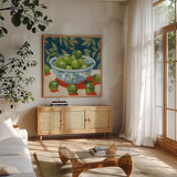 Bowl of Summer Fruit II by Morgan Birch. Shown in a natural wood frame in a cozy modern living room. Available as an archival giclee rolled canvas, fine art paper, or poster print. SKU 104062a.