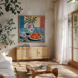 Peach Season by Morgan Birch. Shown in a natural wood frame in a cozy modern living room. Available as an archival giclee rolled canvas, fine art paper, or poster print. SKU 104058a.