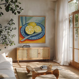 Sliced Lemons on Plates by Morgan Birch. Shown in a natural wood frame in a cozy modern living room. Available as an archival giclee rolled canvas, fine art paper, or poster print. SKU 103136a.