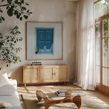 Stucco Window View by Morgan Birch. Shown in a natural wood frame in a cozy modern living room. Available as an archival giclee rolled canvas, fine art paper, or poster print. SKU 103112a.