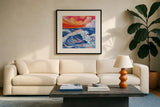 Waves Crashing With Sunset by Morgan Birch. Displayed in a glass frame with matte in a clean modern living room. Available as an archival giclee rolled canvas, fine art paper, or poster print. SKU 103117a.