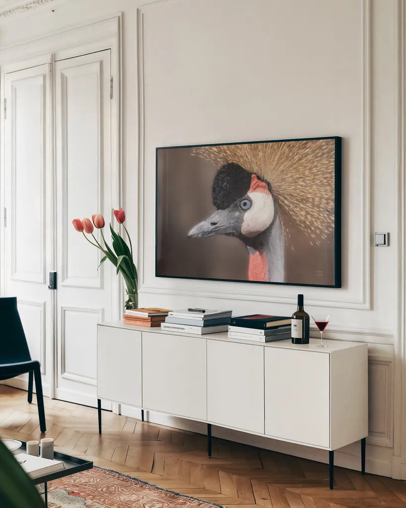 African Crowned Crane by Nathan Larson. shown as a framed stretched canvas in a living room above a console. Available as a archival giclee rolled canvas, fine art paper, or poster print. SKU 82300i.