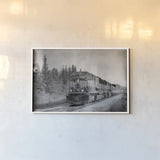 Alaskan Train by Nathan Larson. shown as a paper print in a white frame. Available as a archival giclee rolled canvas, fine art paper, or poster print. SKU 94125i.