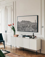 American Borderlands by Nathan Larson. shown as a framed stretched canvas in a living room above a console. Available as a archival giclee rolled canvas, fine art paper, or poster print. SKU 90437i.