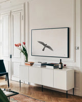 American Kestrel by Nathan Larson. shown as a framed stretched canvas in a living room above a console. Available as a archival giclee rolled canvas, fine art paper, or poster print. SKU 92579i.