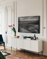 Aqueduct IV by Nathan Larson. shown as a framed stretched canvas in a living room above a console. Available as a archival giclee rolled canvas, fine art paper, or poster print. SKU 89237i.