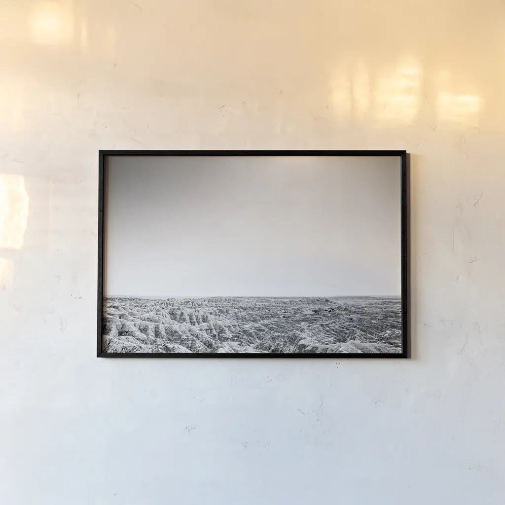 Badland Expanse by Nathan Larson. shown as a paper print in a black flame. Available as a archival giclee rolled canvas, fine art paper, or poster print. SKU 80631i.
