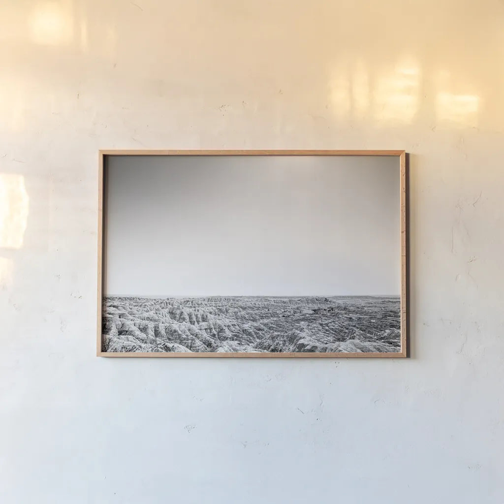 Badland Expanse by Nathan Larson. shown as a paper print in a natural frame. Available as a archival giclee rolled canvas, fine art paper, or poster print. SKU 80631i.