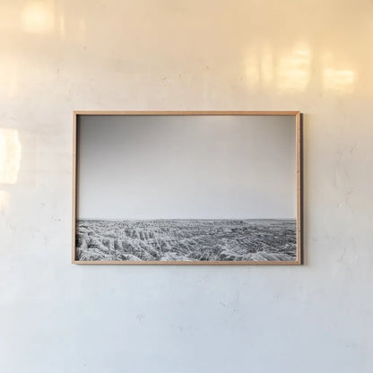 Badland Expanse by Nathan Larson. shown as a paper print in a natural frame. Available as a archival giclee rolled canvas, fine art paper, or poster print. SKU 80631i.