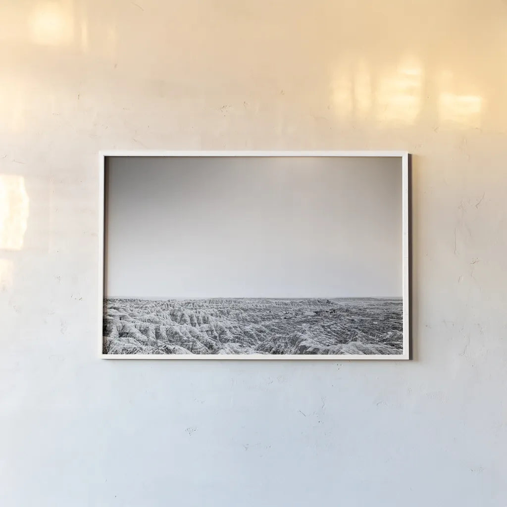 Badland Expanse by Nathan Larson. shown as a paper print in a white frame. Available as a archival giclee rolled canvas, fine art paper, or poster print. SKU 80631i.