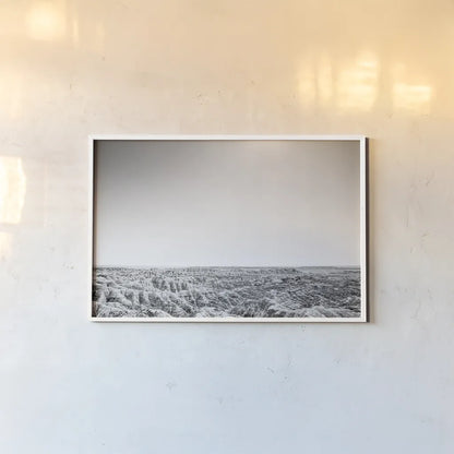 Badland Expanse by Nathan Larson. shown as a paper print in a white frame. Available as a archival giclee rolled canvas, fine art paper, or poster print. SKU 80631i.