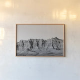 Badlands BW Crop by Nathan Larson. shown as a paper print in a natural frame. Available as a archival giclee rolled canvas, fine art paper, or poster print. SKU 77273i.