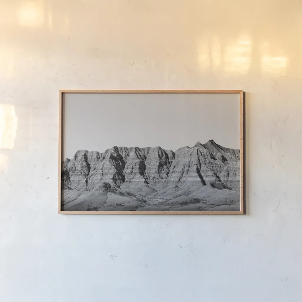 Badlands BW Crop by Nathan Larson. shown as a paper print in a natural frame. Available as a archival giclee rolled canvas, fine art paper, or poster print. SKU 77273i.