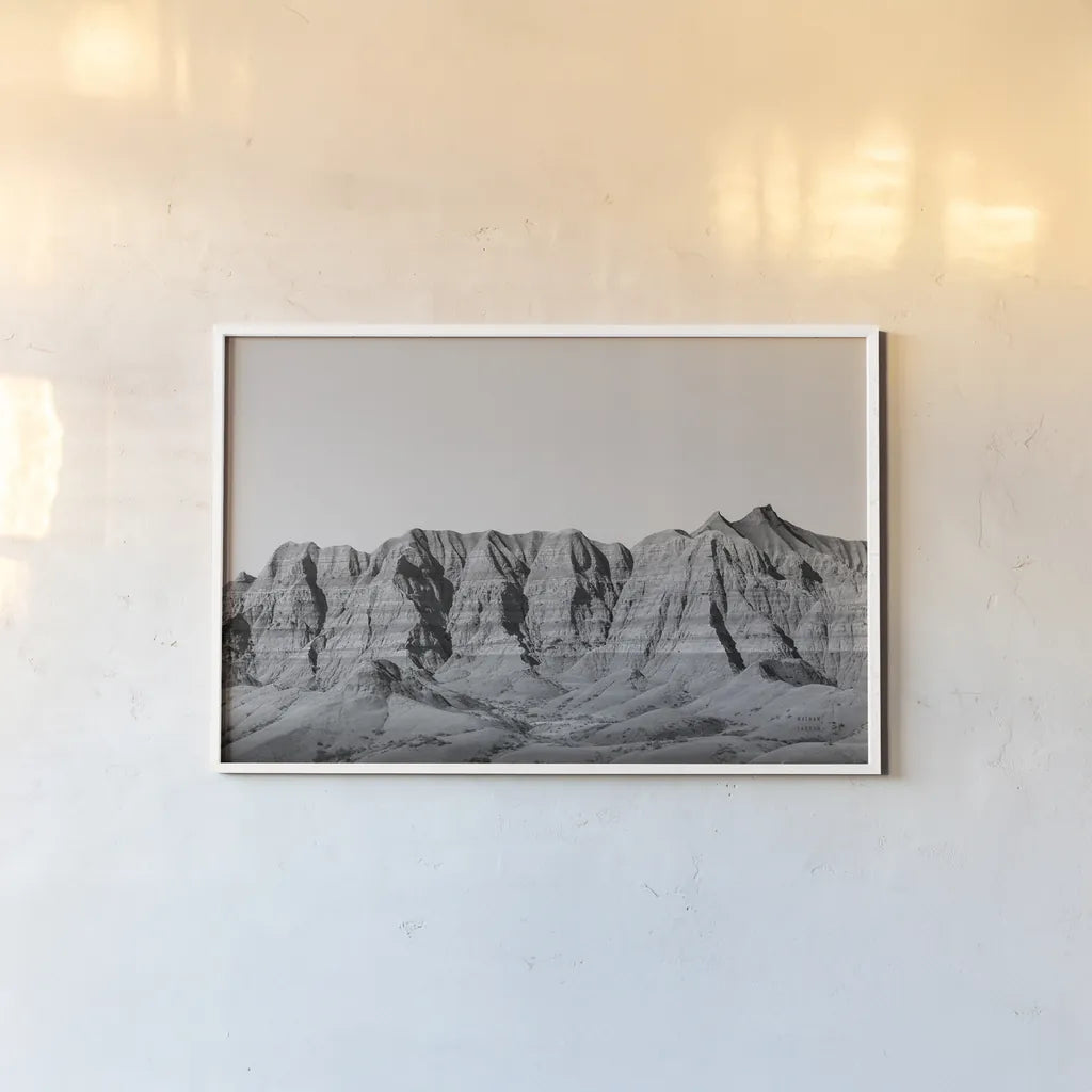 Badlands BW Crop by Nathan Larson. shown as a paper print in a white frame. Available as a archival giclee rolled canvas, fine art paper, or poster print. SKU 77273i.