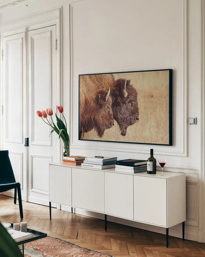 Bison Pair by Nathan Larson. shown as a framed stretched canvas in a living room above a console. Available as a archival giclee rolled canvas, fine art paper, or poster print. SKU 87941i.