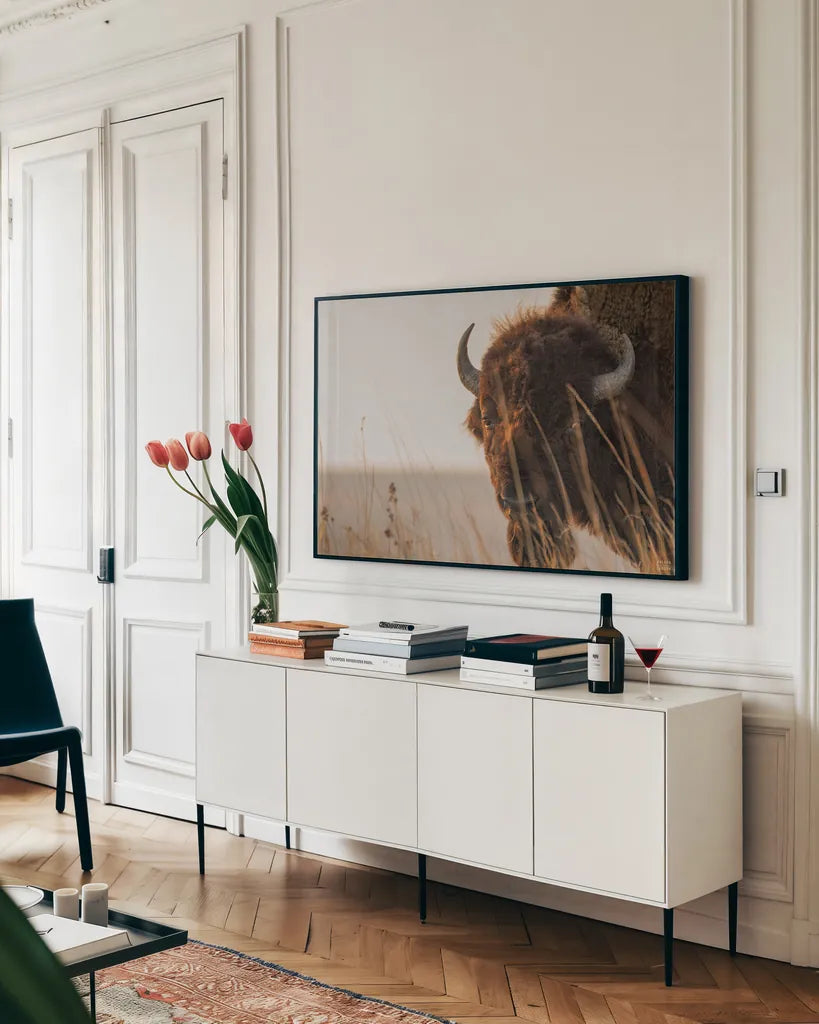 Bison Sunset by Nathan Larson. shown as a framed stretched canvas in a living room above a console. Available as a archival giclee rolled canvas, fine art paper, or poster print. SKU 98333i.