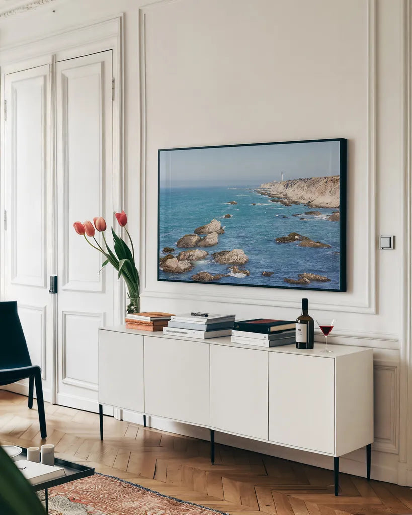 California Lighthouse by Nathan Larson. shown as a framed stretched canvas in a living room above a console. Available as a archival giclee rolled canvas, fine art paper, or poster print. SKU 90177i.