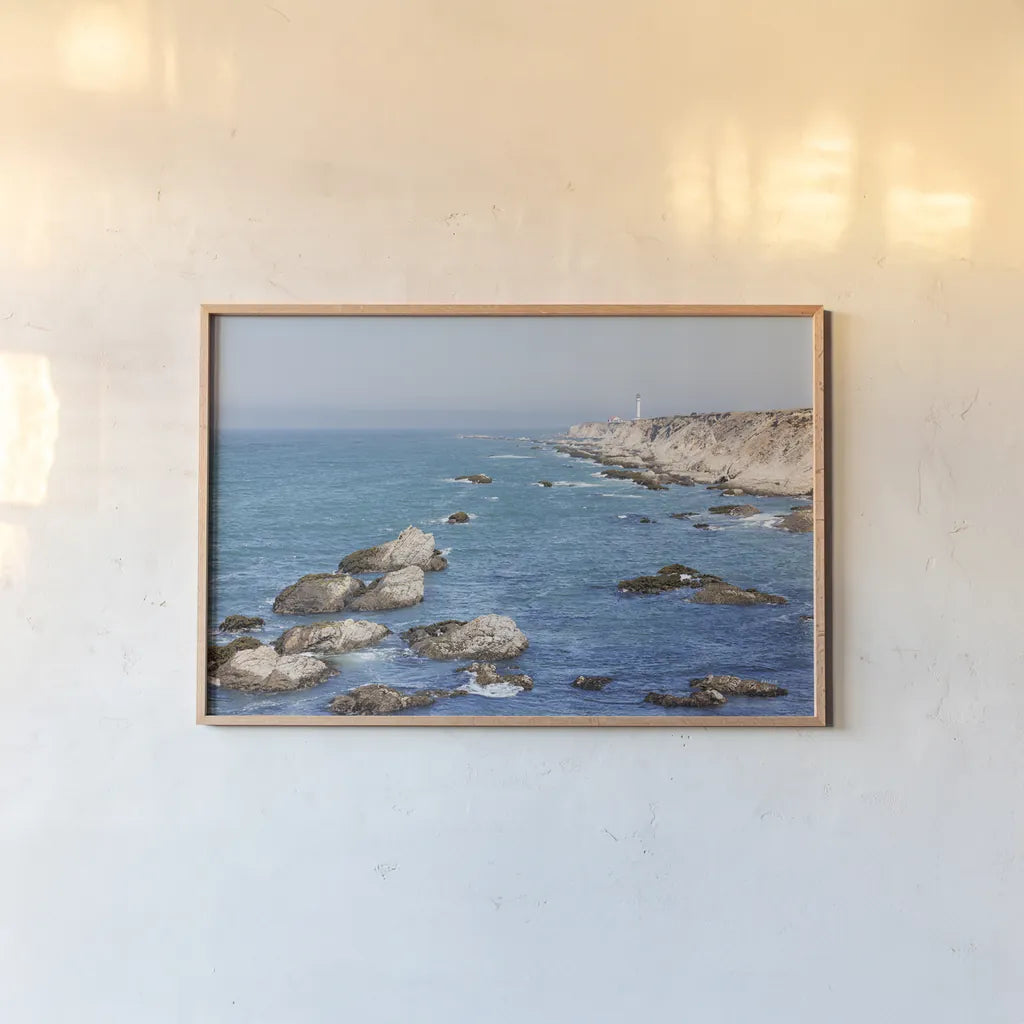 California Lighthouse by Nathan Larson. shown as a paper print in a natural frame. Available as a archival giclee rolled canvas, fine art paper, or poster print. SKU 90177i.