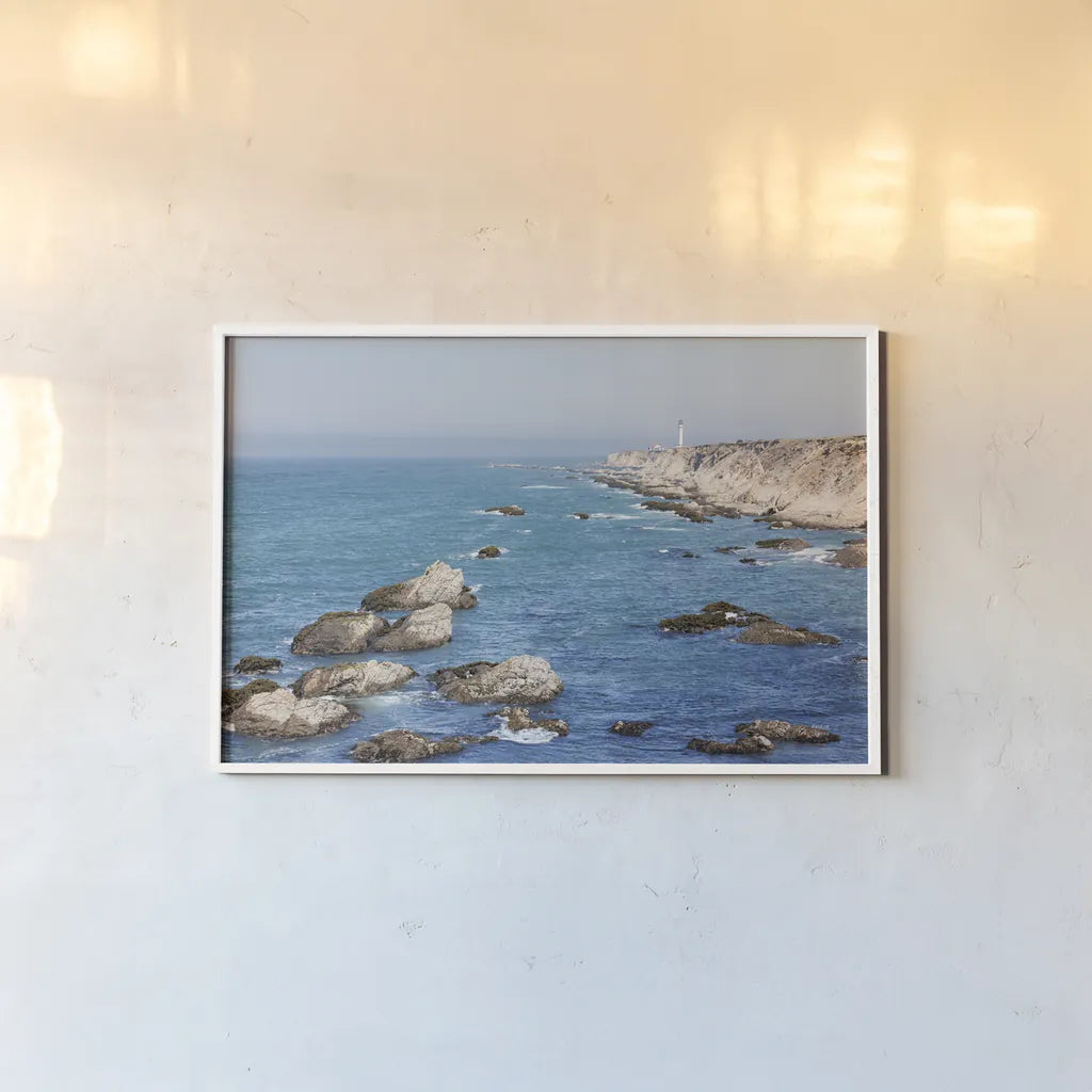 California Lighthouse by Nathan Larson. shown as a paper print in a white frame. Available as a archival giclee rolled canvas, fine art paper, or poster print. SKU 90177i.