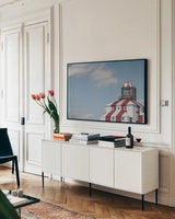 Cape Bona Vista Lighthouse I by Nathan Larson. shown as a framed stretched canvas in a living room above a console. Available as a archival giclee rolled canvas, fine art paper, or poster print. SKU 103218i.