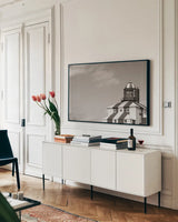 Cape Bona Vista Lighthouse I Sepia by Nathan Larson. shown as a framed stretched canvas in a living room above a console. Available as a archival giclee rolled canvas, fine art paper, or poster print. SKU 103219i.