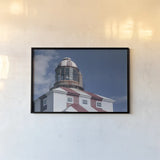 Cape Bona Vista Lighthouse II by Nathan Larson. shown as a paper print in a black flame. Available as a archival giclee rolled canvas, fine art paper, or poster print. SKU 103220i.