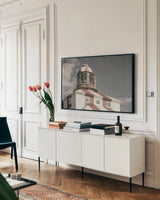 Cape Bona Vista Lighthouse II Desaturated by Nathan Larson. shown as a framed stretched canvas in a living room above a console. Available as a archival giclee rolled canvas, fine art paper, or poster print. SKU 103221i.
