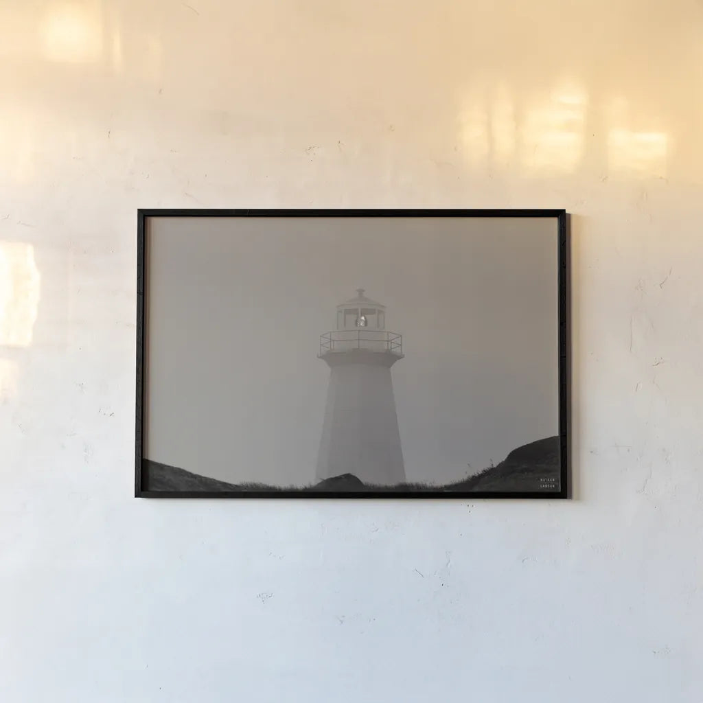Cape Spear Lighthouse by Nathan Larson. shown as a paper print in a black flame. Available as a archival giclee rolled canvas, fine art paper, or poster print. SKU 100500i.